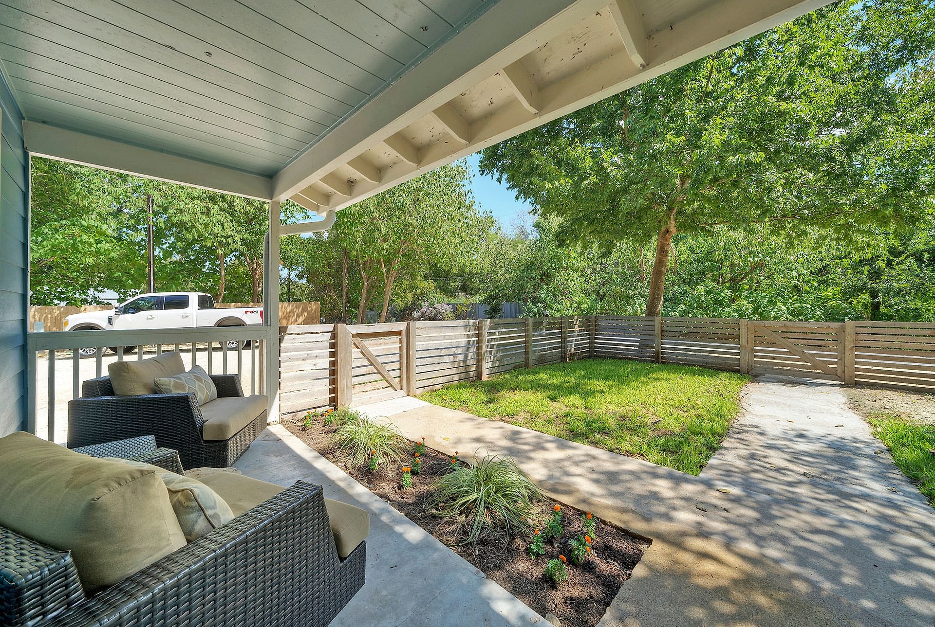 Covered patio seating looking out to the yard at River Bend Bliss